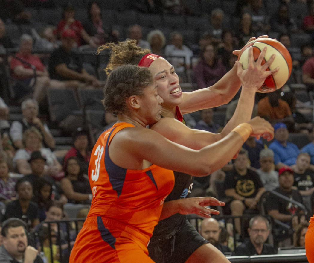 Las Vegas Aces forward Dearica Hamby (5) attempts a play against Connecticut Sun forward Morgan ...