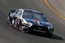 Kevin Harvick races out of turn one during a NASCAR Cup Series auto race at Michigan Internatio ...