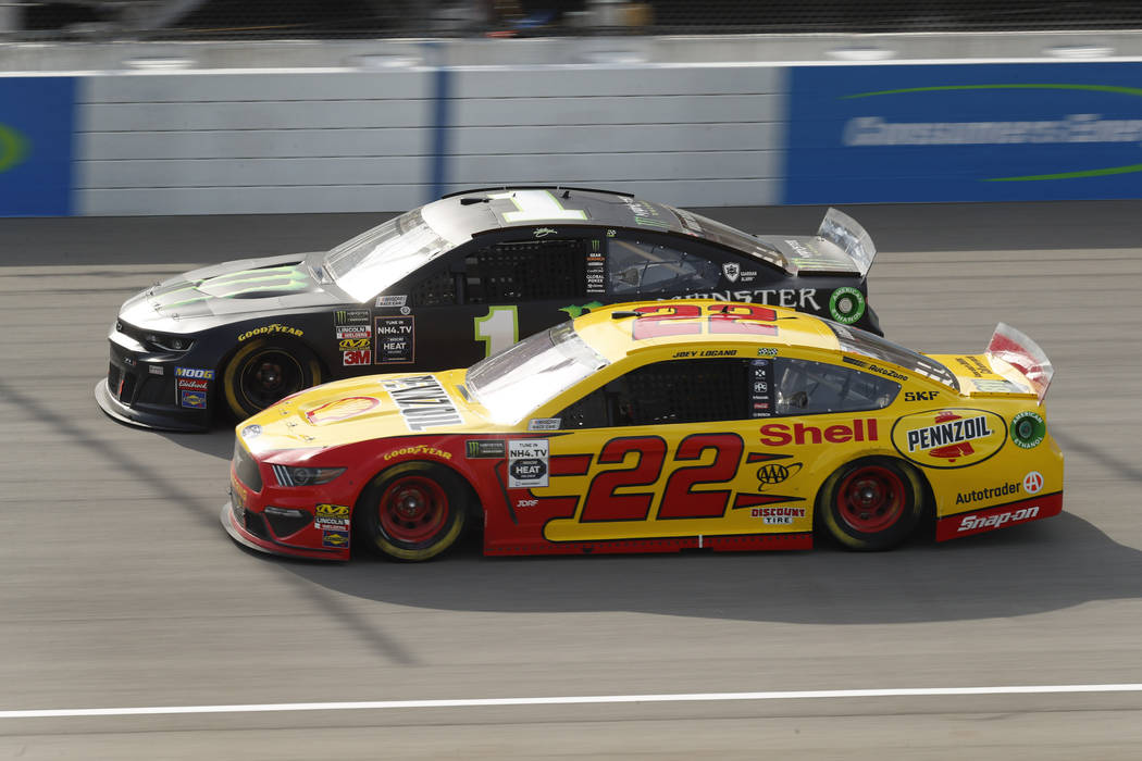 Joey Logano (22) races Kurt Busch (1) during a NASCAR Cup Series auto race at Michigan Internat ...