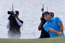 Patrick Reed hits out of a bunker on the fourth hole in the final round of the Northern Trust g ...