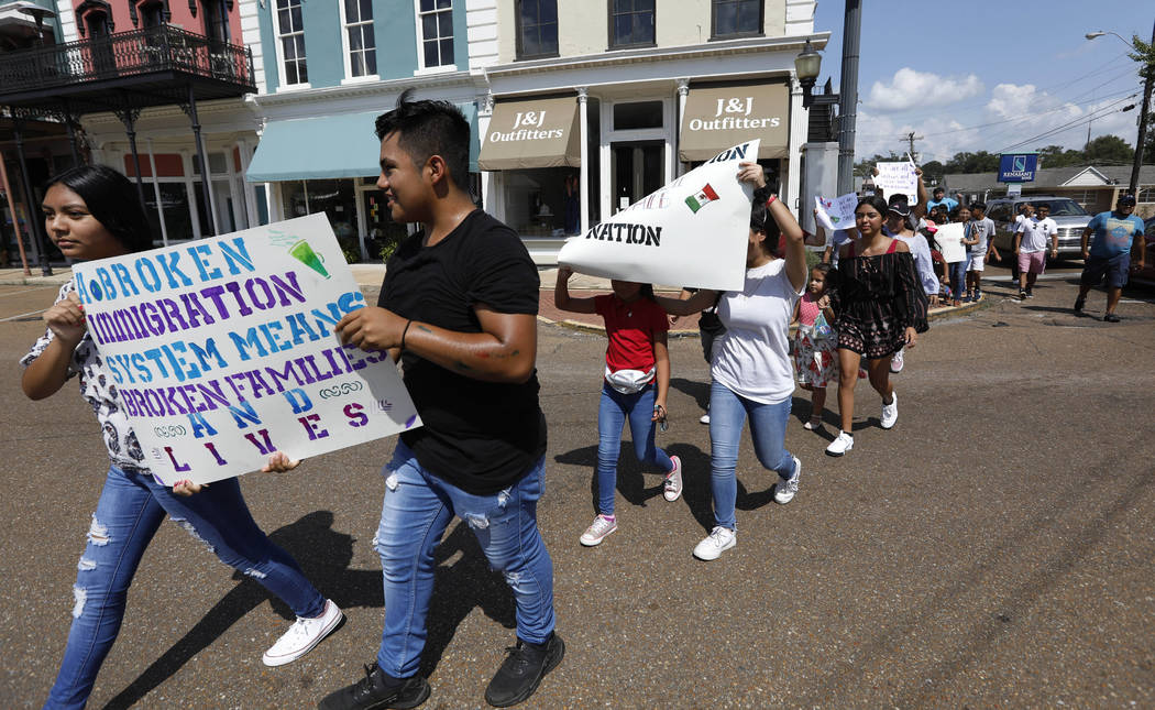 Children of mainly Latino immigrant parents hold signs in support of them and those individuals ...