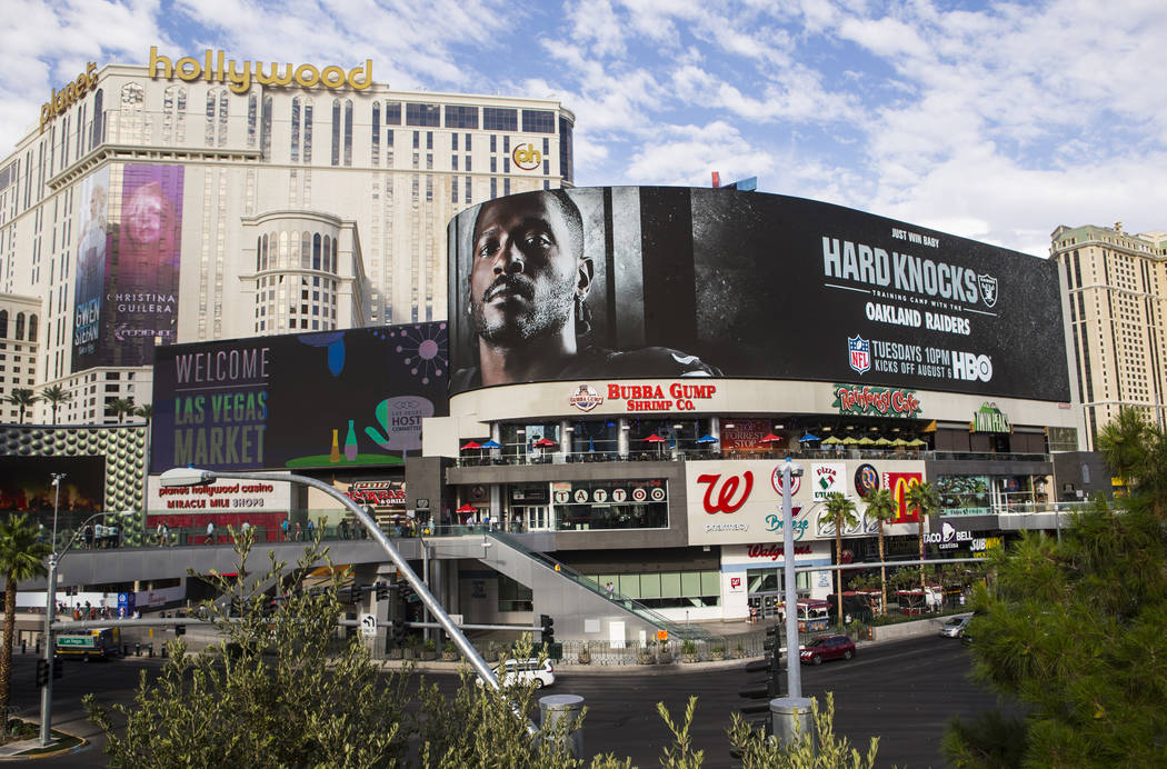 A digital billboard displays Oakland Raiders' Antonio Brown in an advertisement for the upcomin ...