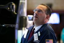 Specialist Anthony Matsic works at his post on the floor of the New York Stock Exchange, Monday ...