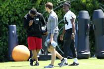 Oakland Raiders wide receiver Antonio Brown (84), right, walks on the field during the NFL team ...