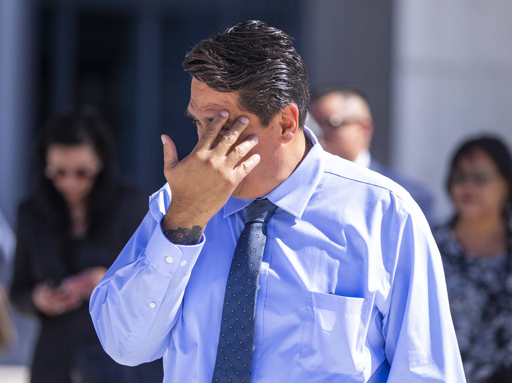Defendant Bradley Campos hides his face while departing the the Lloyd D. George Courthouse foll ...