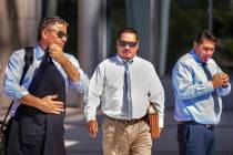 Counselor Mark Fleming, left, and defendant Albert Lopez walk past defendant Bradley Campos out ...