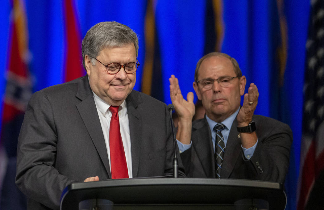 United States Attorney General William Barr, left, is applauded by F.O.P. President Chuck Cante ...