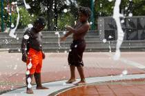 Kai Frazier and Chance Seawright, brothers visiting from Aiken, South Carolina, cool off while ...