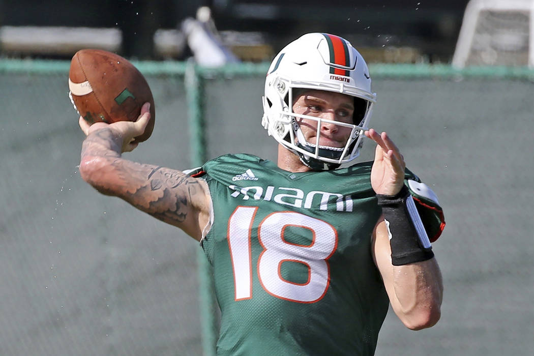 Miami quarterback Tate Martell (18) throws the ball during NCAA college football practice in Co ...