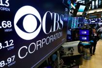 The logo for the CBS Corporation appears above a trading post on the floor of the New York Stoc ...