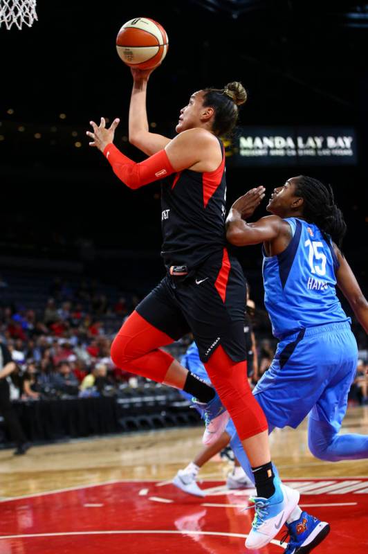 Las Vegas Aces' Kayla McBride goes to the basket past Atlanta Dream's Tiffany Hayes (15) during ...