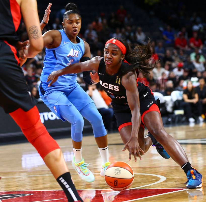 Las Vegas Aces' Jackie Young drives the ball past Atlanta Dream's Alex Bentley during the secon ...