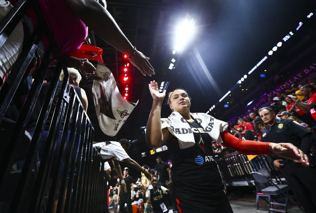 Las Vegas Aces' Kayla McBride high-fives fans after a WNBA basketball game against Atlanta Drea ...