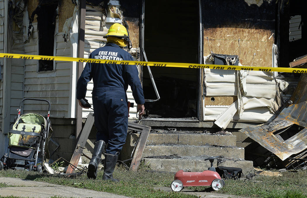 Erie Bureau of Fire Inspector Mark Polanski helps investigate a fatal fire at 1248 West 11th St ...