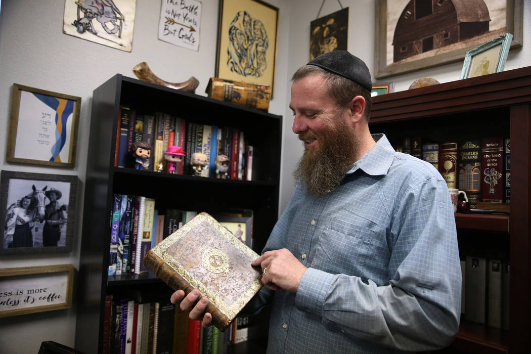 Rabbi Jered Hundley shows his book collection inside the Lev HaShem Messianic Synagogue in Las ...