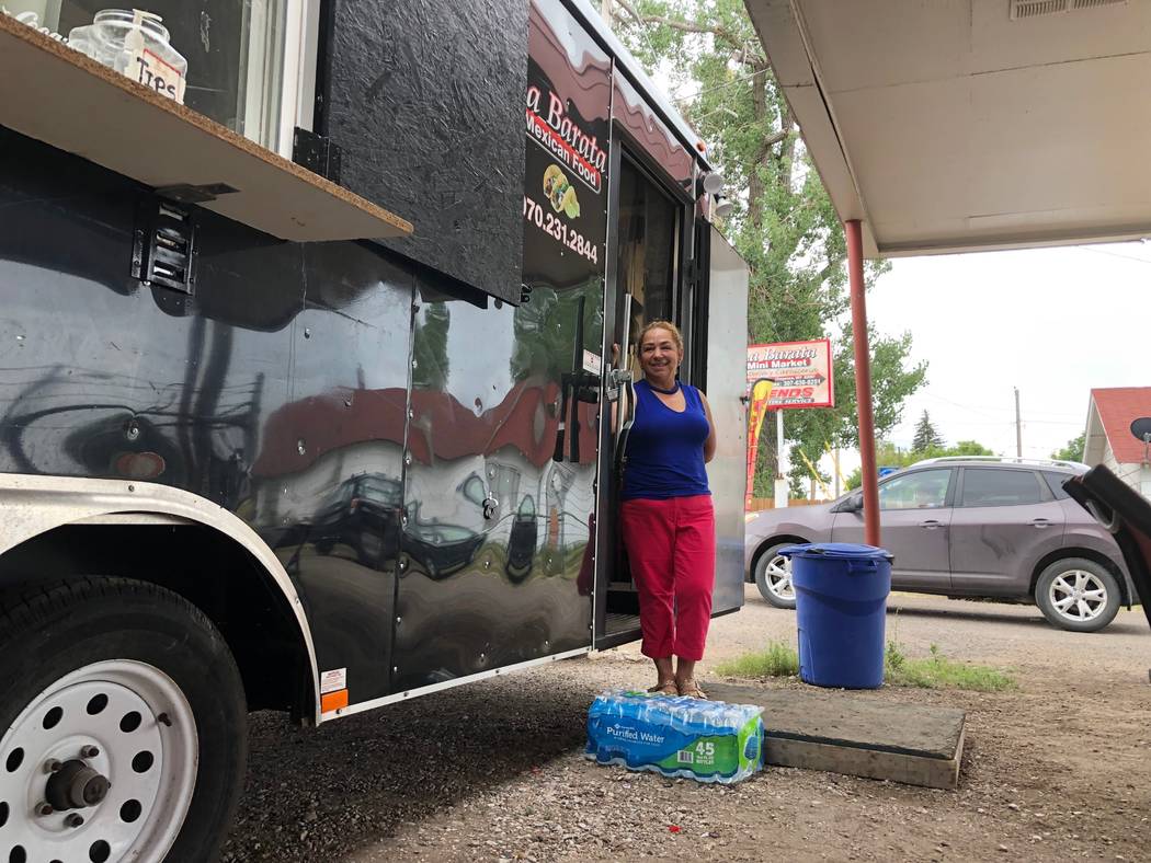 In this Aug. 1, 2019 photo Nena Hermosillo stands outside her taco truck in Cheyenne, Wyo. Chey ...