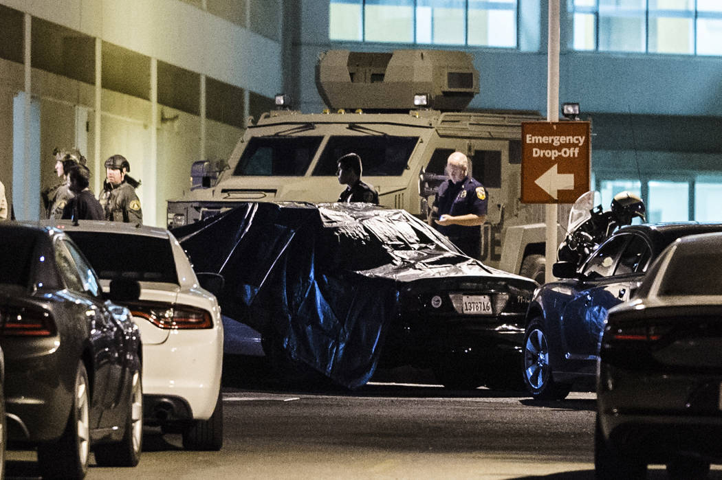 A California Highway Patrol vehicle is covered with a tarp outside the emergency room entrance ...