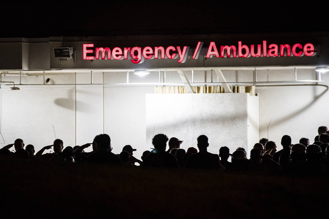 California Highway Patrol Officers gather outside the emergency room entrance to the Riverside ...