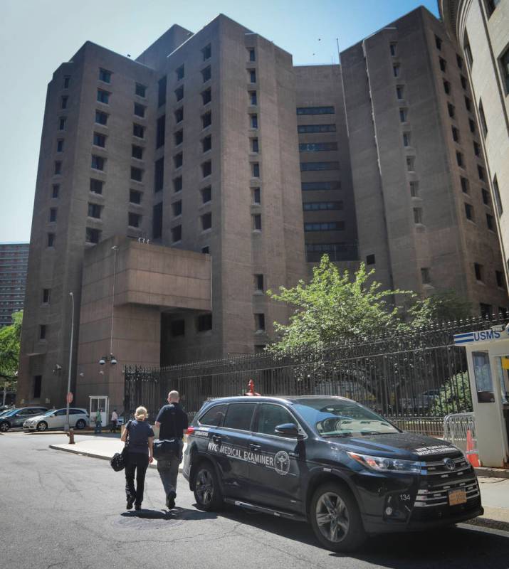 New York City medical examiner personnel leave their vehicle and walk to the Manhattan Correcti ...