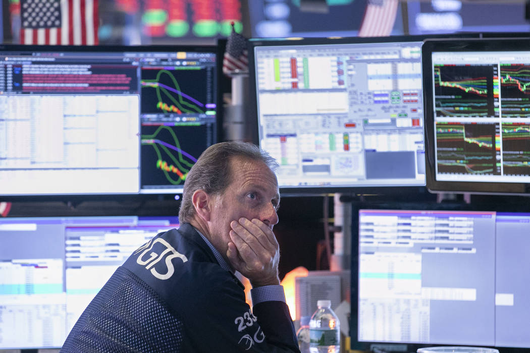 Specialist Glenn Carrel works at his post on the floor of the New York Stock Exchange, Wednesda ...