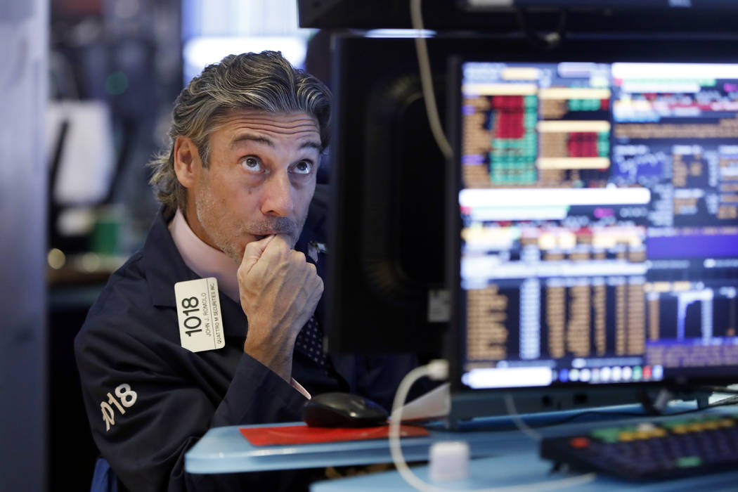 Trader John Romolo works on the floor of the New York Stock Exchange, Wednesday, Aug. 14, 2019. ...