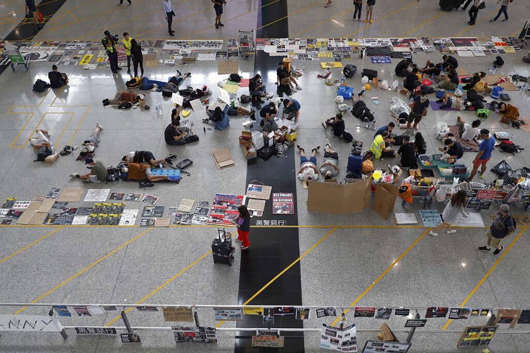 Protesters continue their sit-in rally at the airport in Hong Kong, Wednesday, Aug. 14, 2019. F ...