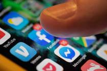 In a Sunday, Aug. 11, 2019, photo, an iPhone displays the apps for Facebook and Messenger. Face ...