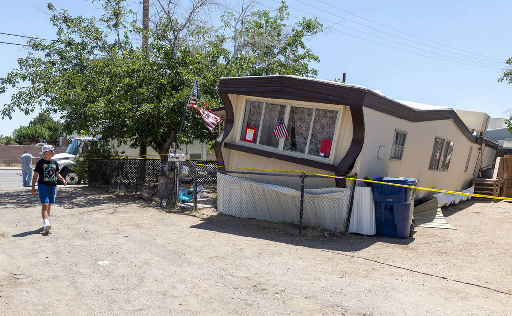 In a July 5, 2019, file photo, a child walks by one of the mobile homes knocked off its foundat ...