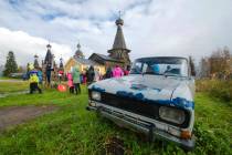 In this photo taken on Oct. 7, 2018, people walk the street with the 18th century Trinity Churc ...