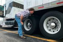 In this June 13, 2019 photo, truck driver Terry Button looks over his trailer during at stop in ...