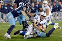 Indianapolis Colts quarterback Andrew Luck (12) is brought down as he scrambles against the Ten ...