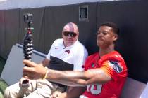 UNLV football head coach Tony Sanchez, left, and linebacker Javin White (16), video log during ...