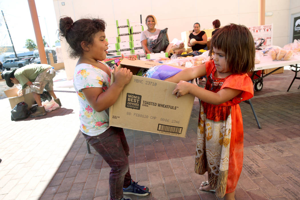 Michelle Morales, 5, left, her sister, Briyit Morales, 3, and their mother, Carina Lopez, rear, ...