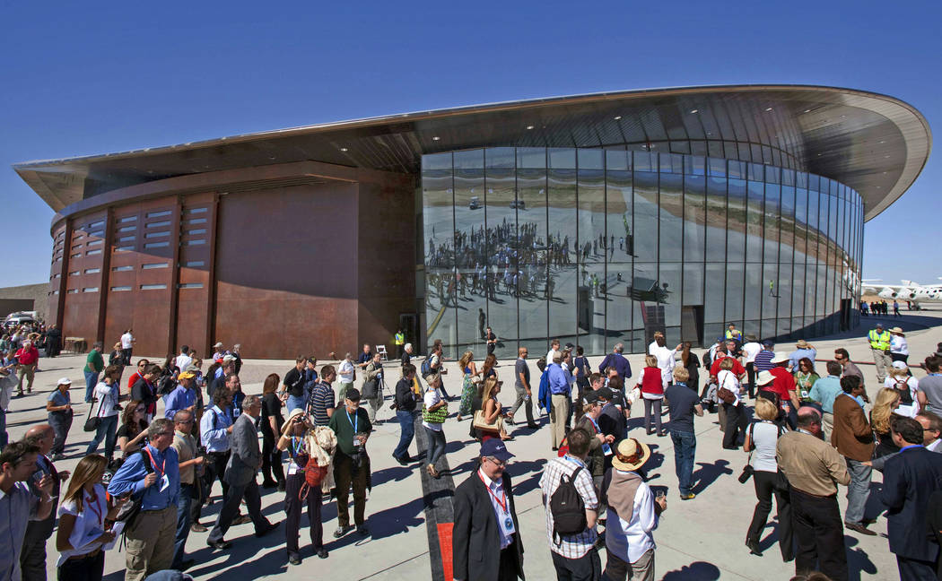FILE - In this Oct. 17, 2011 file photo, guests stand outside the new Spaceport America hangar ...