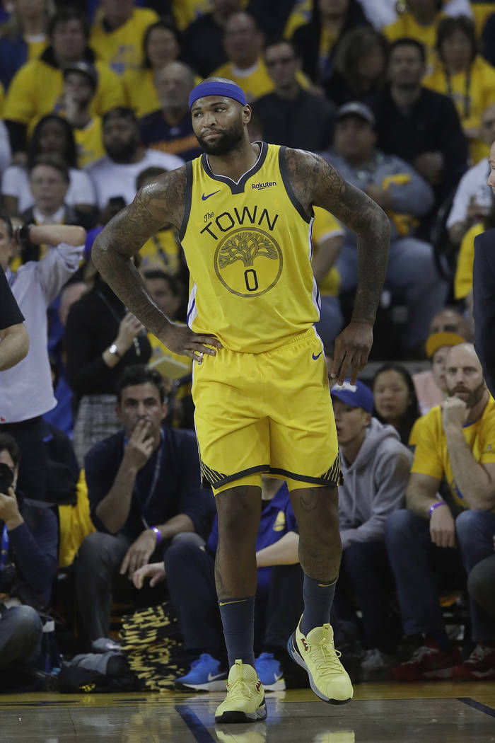 FILE - In this April 15, 2019, file photo, then-Golden State Warriors center DeMarcus Cousins r ...