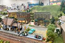 The model town that sits in the middle of the club's meeting room is filled with a series of ri ...