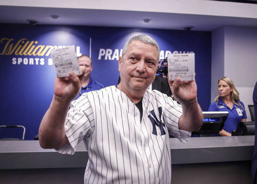 State senator Tony Bisagnano (D-Des Moines) holds up a pair of betting slips after placing the ...