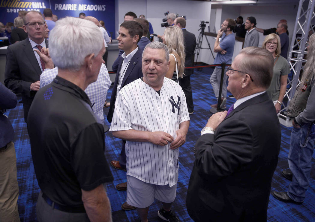 State senator Tony Bisagnano (D-Des Moines) donned a New York Yankees jersey to place the inaug ...