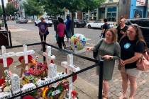 Sabrina Herman, gesturing, visits a makeshift memorial on Wednesday, Aug. 14, 2019, outside Ne ...