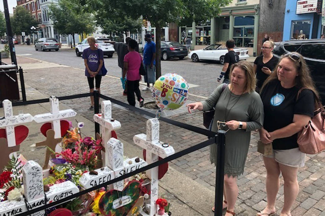Sabrina Herman, gesturing, visits a makeshift memorial on Wednesday, Aug. 14, 2019, outside Ne ...