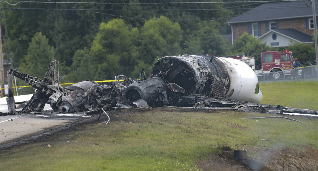 The burned remains of a plane that was carrying NASCAR television analyst and former driver Dal ...