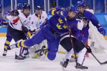 Erika Grahm (24), of Sweden, fights for control of the puck with South Korea's Choi Jiyeon (10) ...