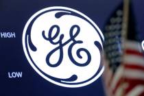 FILE - In this June 26, 2018, file photo the General Electric logo appears above a trading post ...