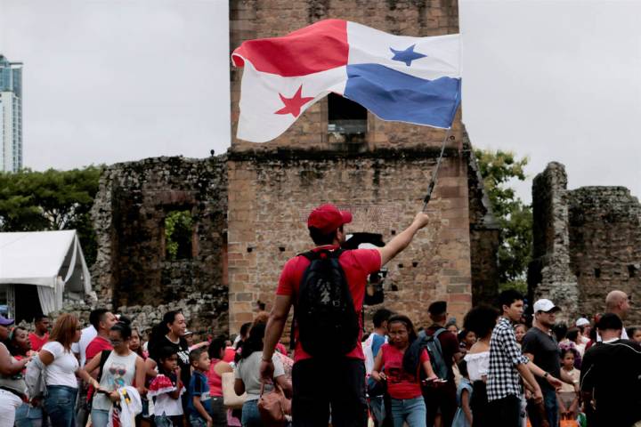 A person waves a Panama flag during the activities celebrating the 500 anniversary of the found ...