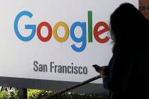 FILE - In this May 1, 2019, file photo, a person walks past a Google sign in San Francisco. Goo ...