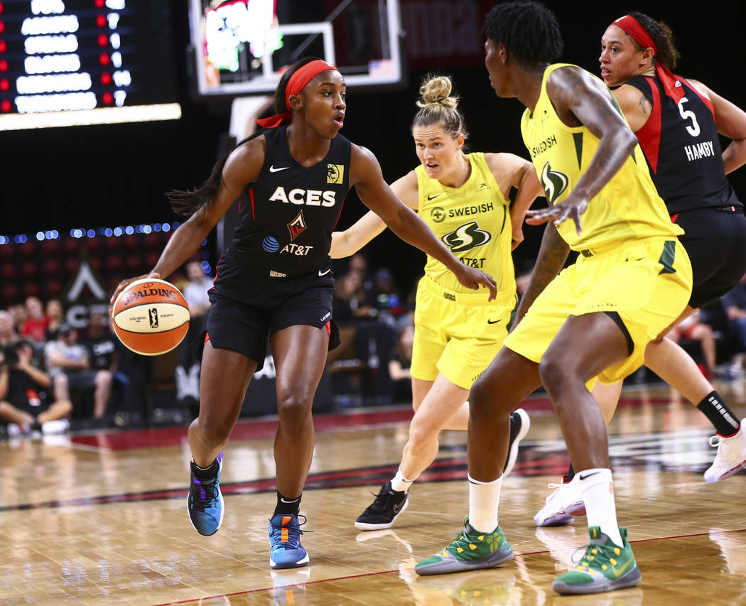 Las Vegas Aces' Jackie Young brings the ball up court against Seattle Storm during the first ha ...