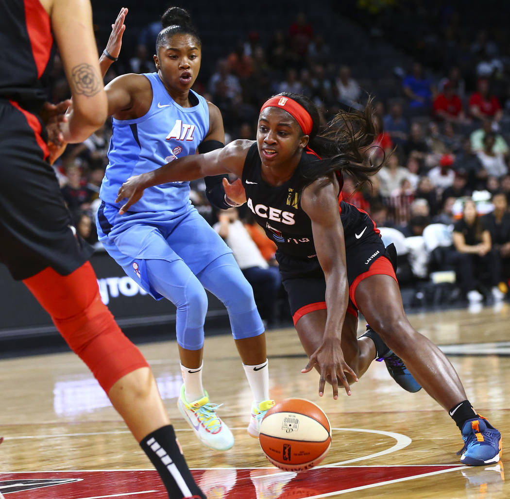 Las Vegas Aces' Jackie Young drives the ball past Atlanta Dream's Alex Bentley during the secon ...