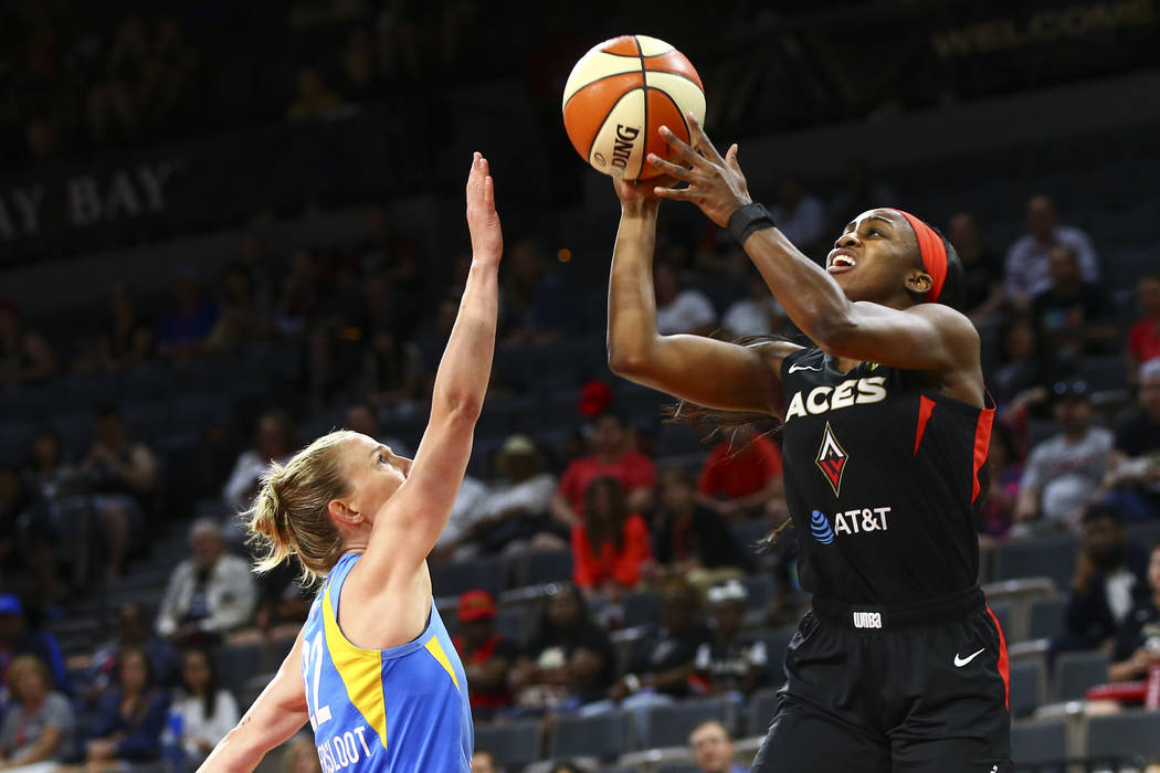 Las Vegas Aces' Jackie Young, right, shoots over Chicago Sky's Courtney Vandersloot (22) during ...