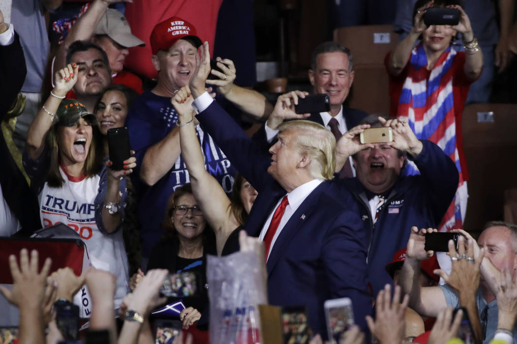 Supporters cheer as President Donald Trump arrives to a campaign rally, Thursday, Aug. 15, 2019 ...