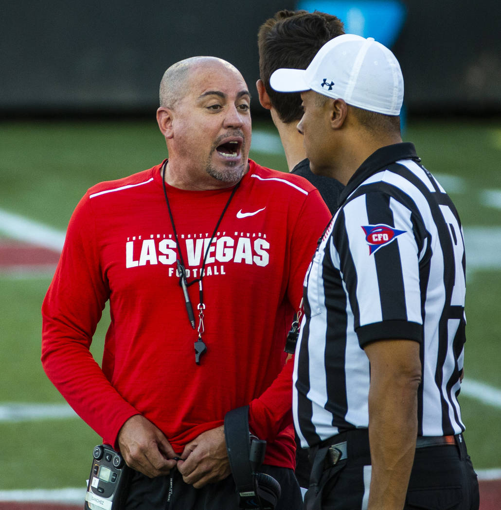 UNLV head coach Tony Sanchez talks with an official on the field during their first major scrim ...